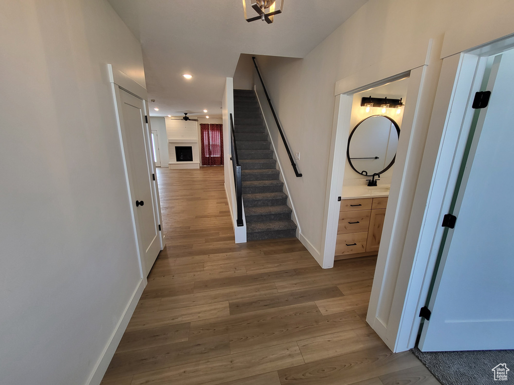 Hallway with hardwood / wood-style floors
