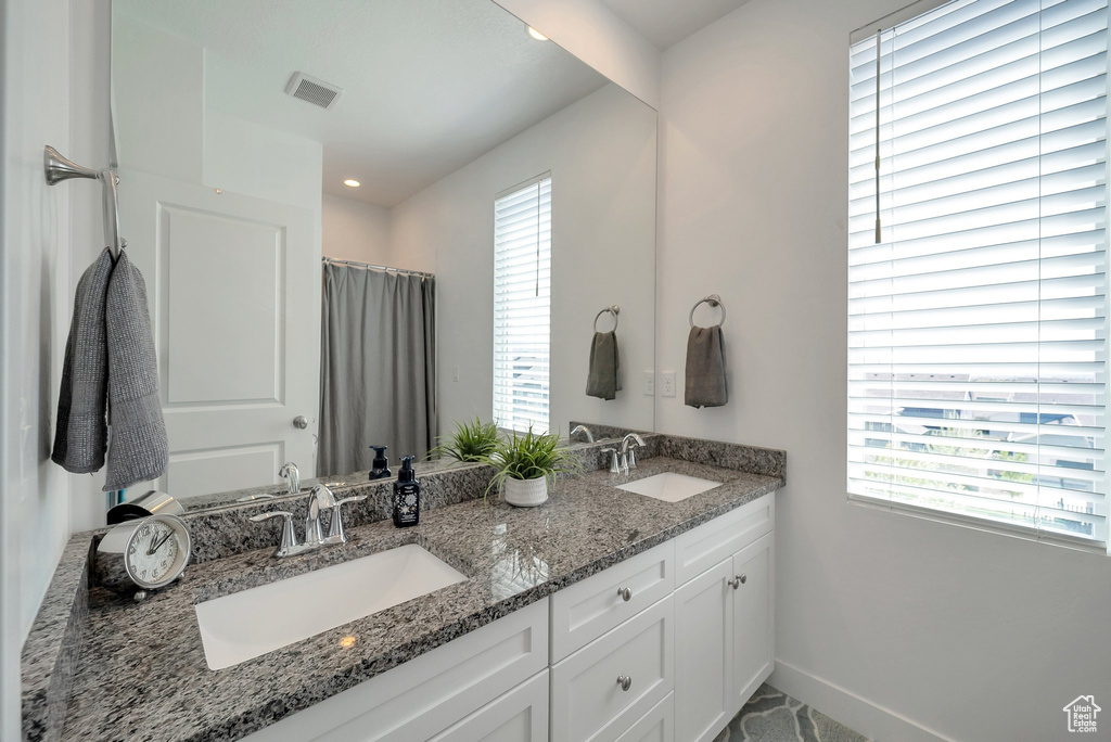 Bathroom with plenty of natural light and dual vanity
