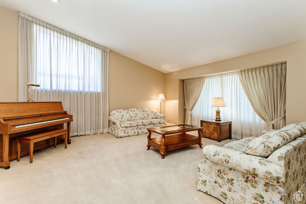 Carpeted living room featuring vaulted ceiling