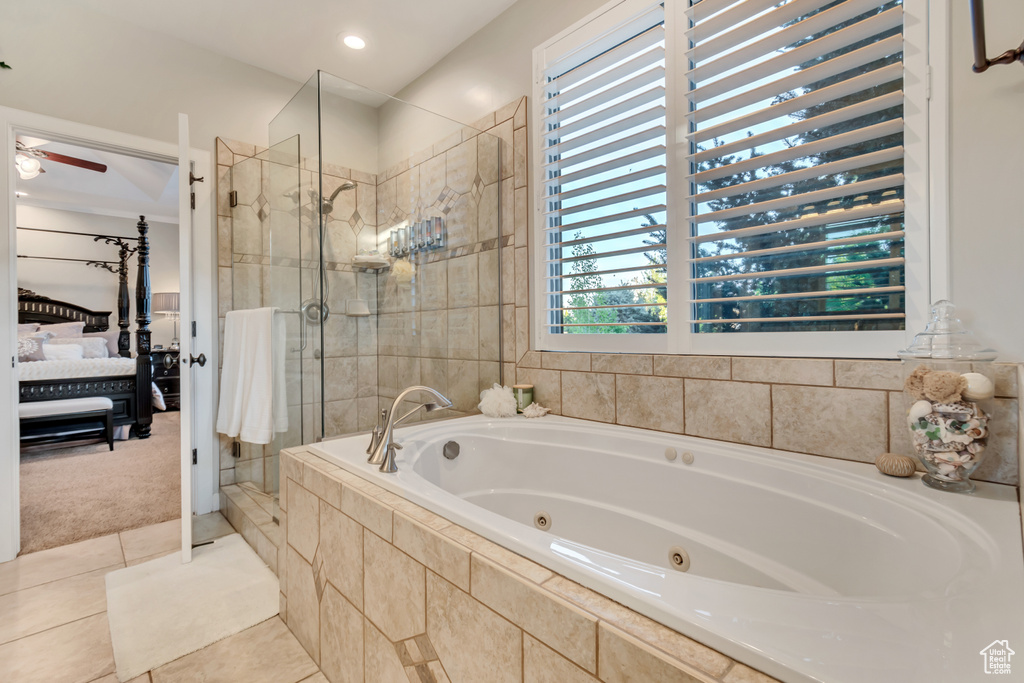 Bathroom featuring tile flooring, ceiling fan, and separate shower and tub