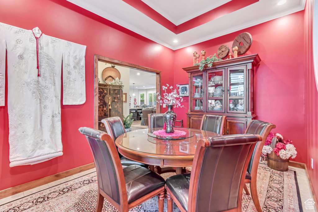 Dining room with ornamental molding and a tray ceiling