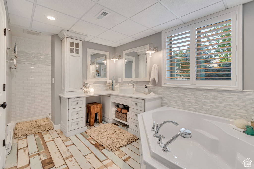 Bathroom with independent shower and bath, vanity, and a paneled ceiling