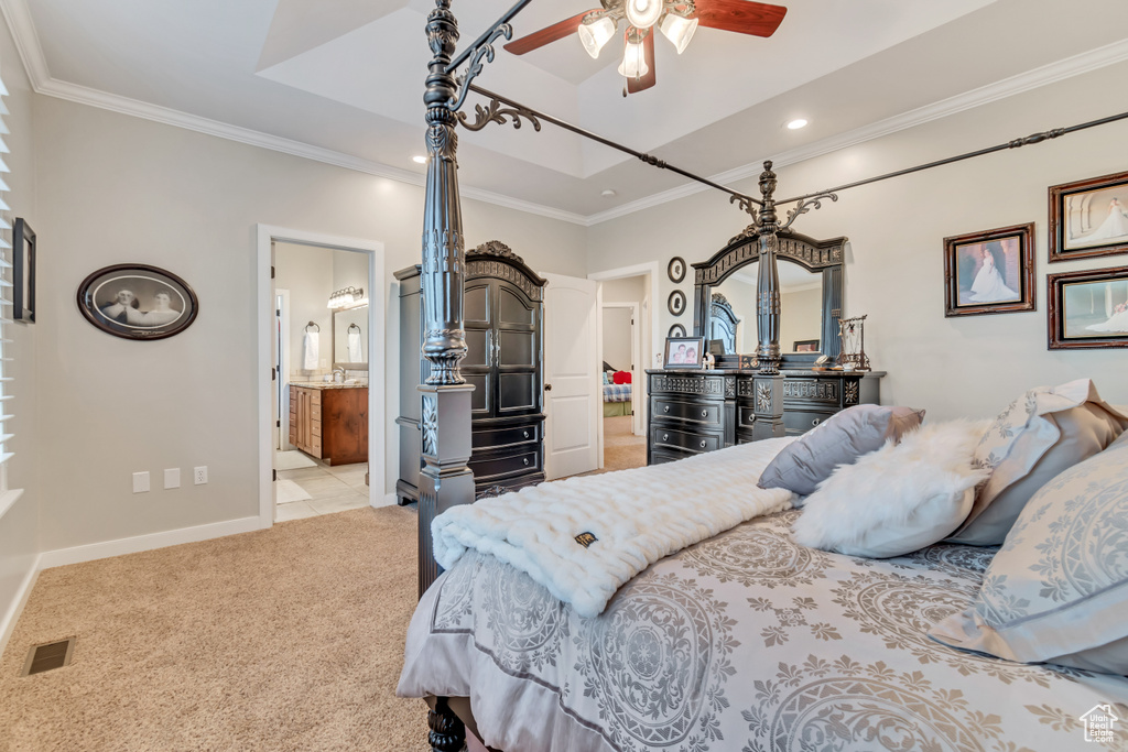 Bedroom with light carpet, connected bathroom, ceiling fan, and ornamental molding