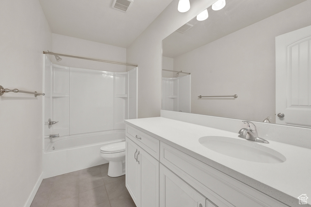 Full bathroom featuring tile flooring, shower / washtub combination, toilet, and oversized vanity