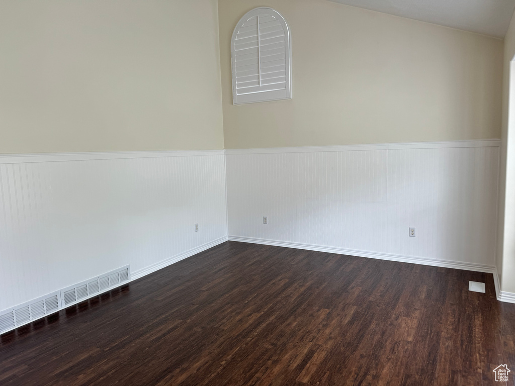 Empty room with hardwood / wood-style floors
