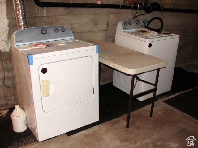 Clothes washing area featuring washing machine and clothes dryer