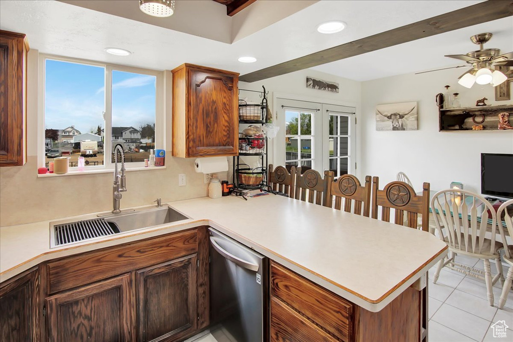 Kitchen featuring beamed ceiling, sink, light tile floors, dishwasher, and ceiling fan