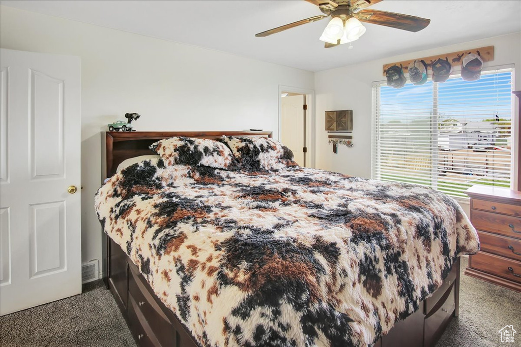 Bedroom featuring ceiling fan and carpet