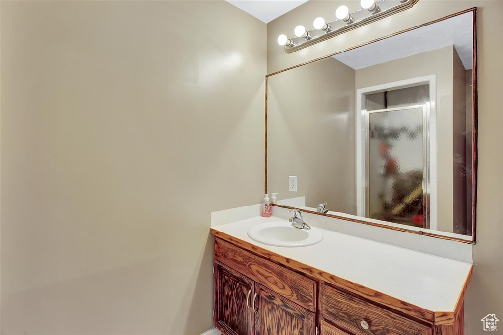 Bathroom with vanity with extensive cabinet space