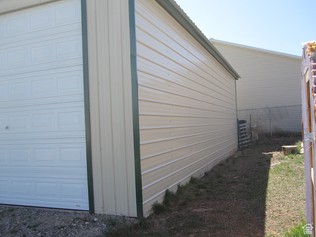 View of side of property with a garage