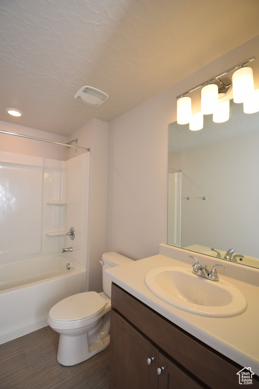 Full bathroom with shower / washtub combination, tile flooring, vanity, and toilet