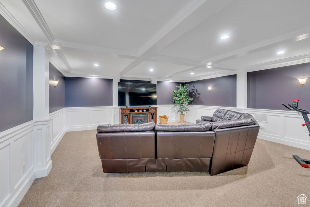 Interior space with coffered ceiling, light colored carpet, and beam ceiling