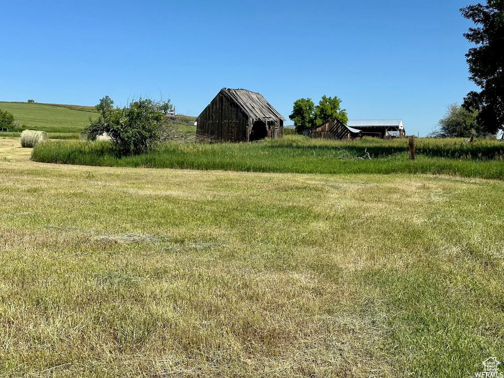 View of yard featuring a rural view and an outdoor structure