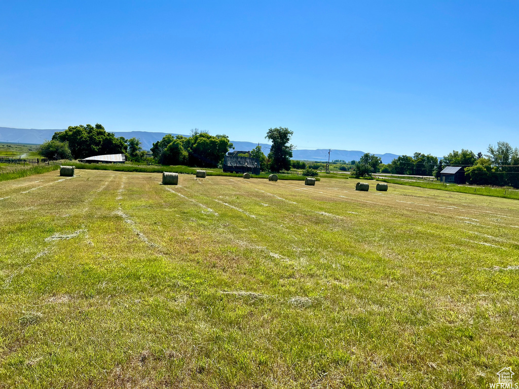 View of yard with a mountain view and a rural view