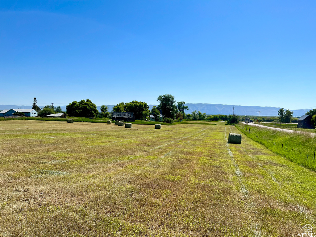 View of yard featuring a rural view and a mountain view