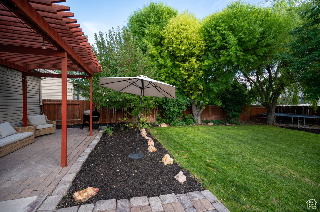 View of yard featuring a pergola and a patio area