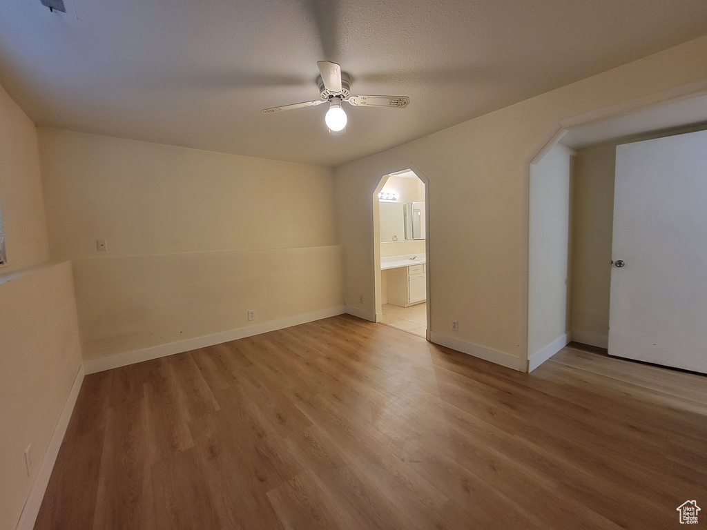 Unfurnished room featuring hardwood / wood-style flooring and ceiling fan