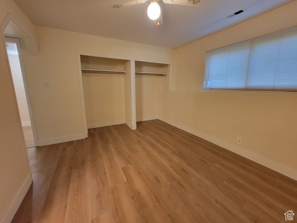 Unfurnished bedroom featuring ceiling fan and hardwood / wood-style flooring
