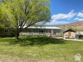 Back of house featuring a lawn