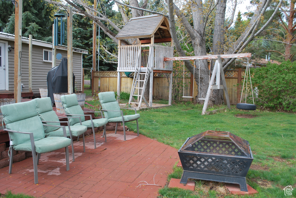 View of patio featuring a playground and an outdoor hangout area