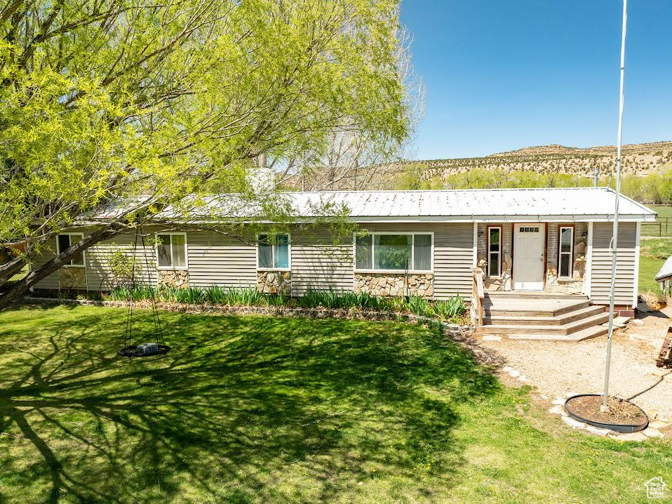 Ranch-style home featuring a front yard