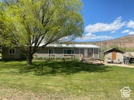 Back of house featuring a lawn