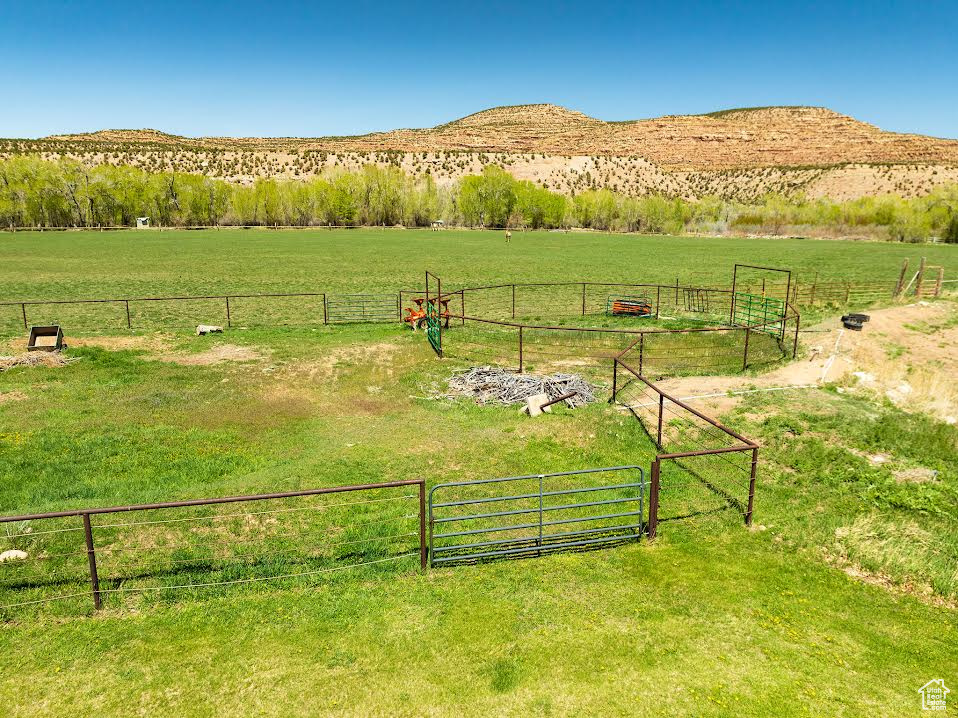 Exterior space with a rural view, a yard, and a mountain view