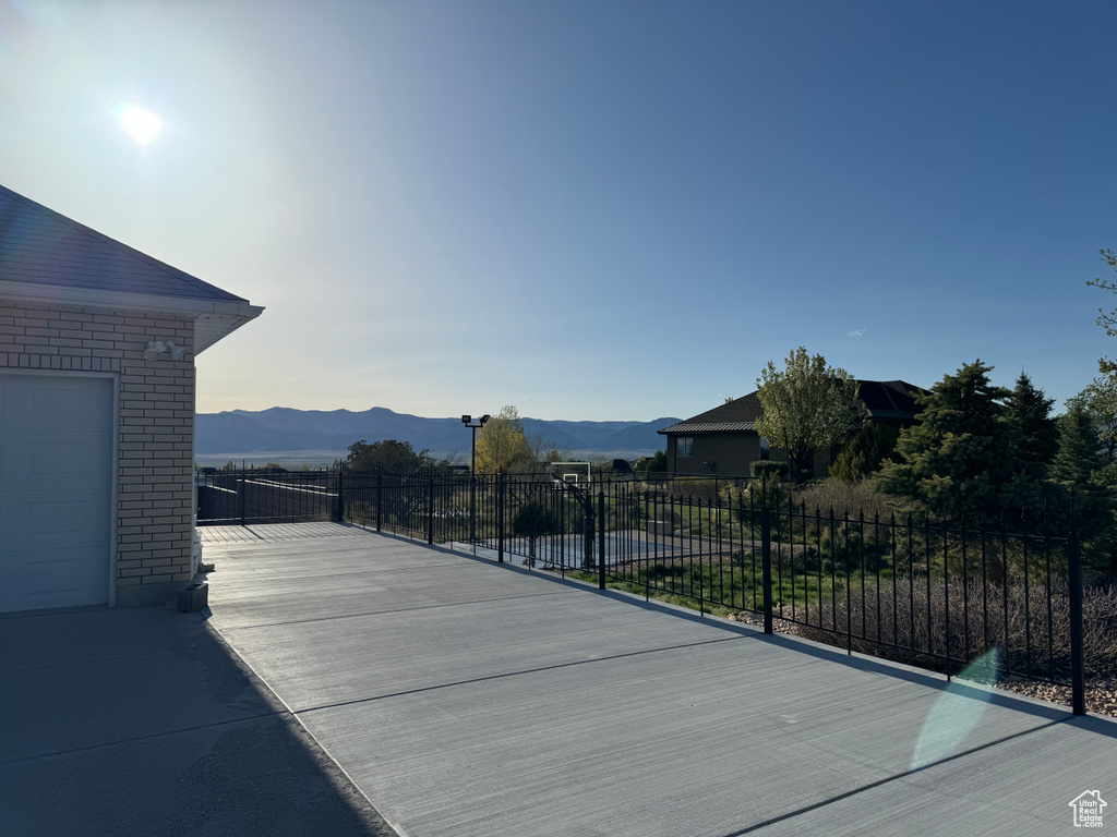 View of patio with a mountain view and a garage
