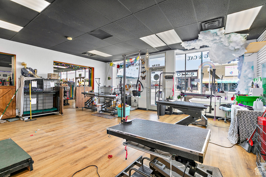 Workout area featuring hardwood / wood-style flooring and a drop ceiling