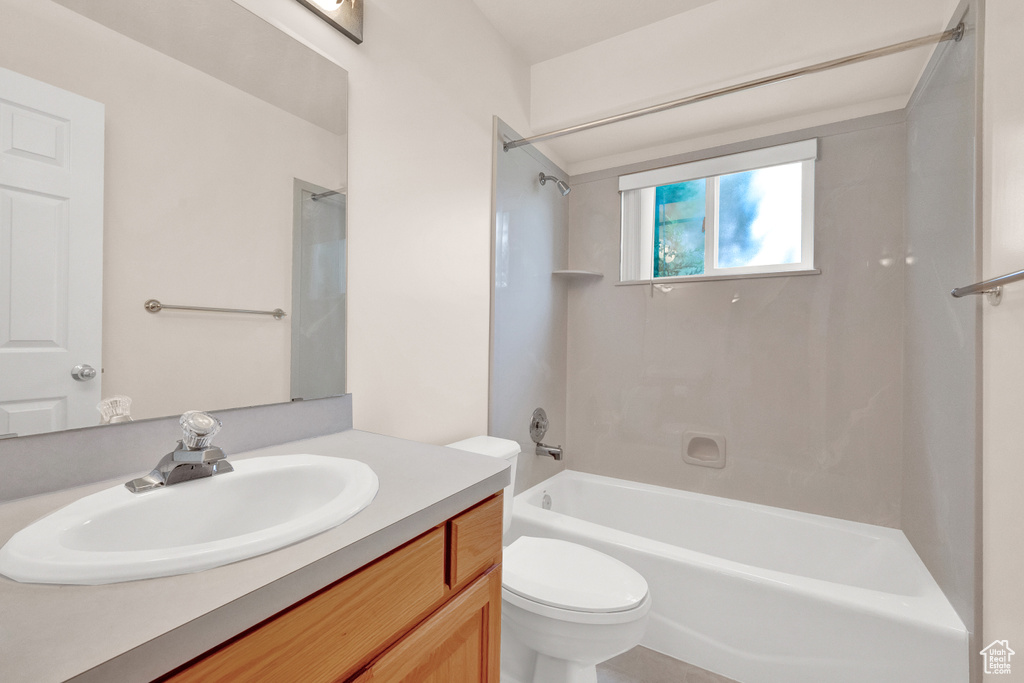 Full bathroom featuring shower / tub combination, vanity, and toilet
