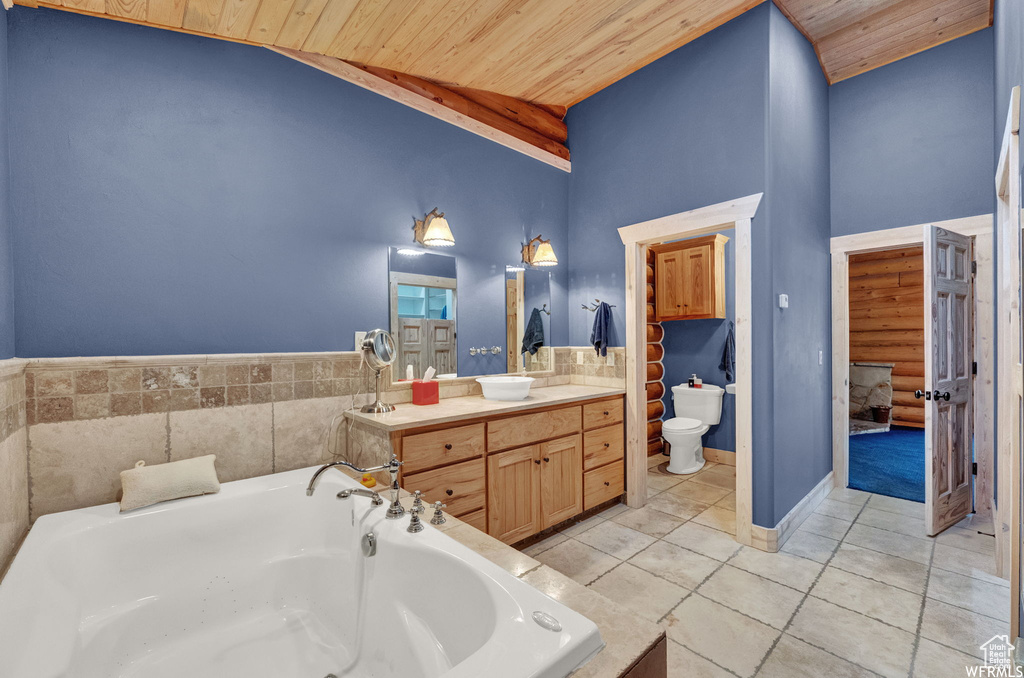 Bathroom featuring high vaulted ceiling, oversized vanity, a tub, wood ceiling, and a bidet