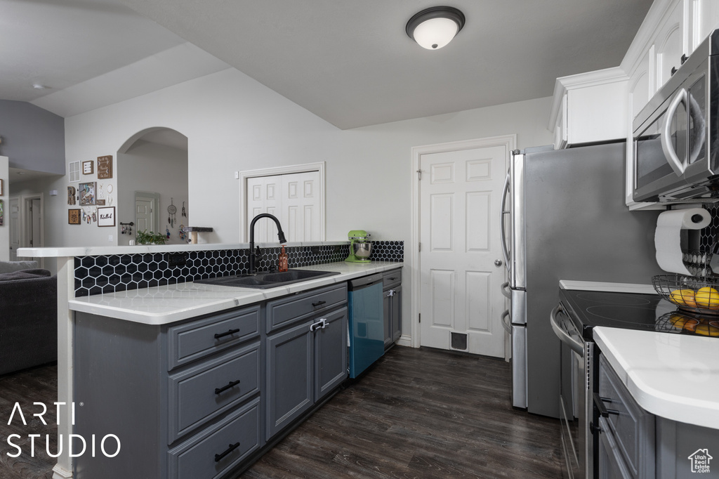 Kitchen featuring sink, gray cabinetry, white cabinetry, stainless steel appliances, and dark hardwood / wood-style floors