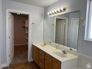 Bathroom with dual sinks, tile floors, and oversized vanity