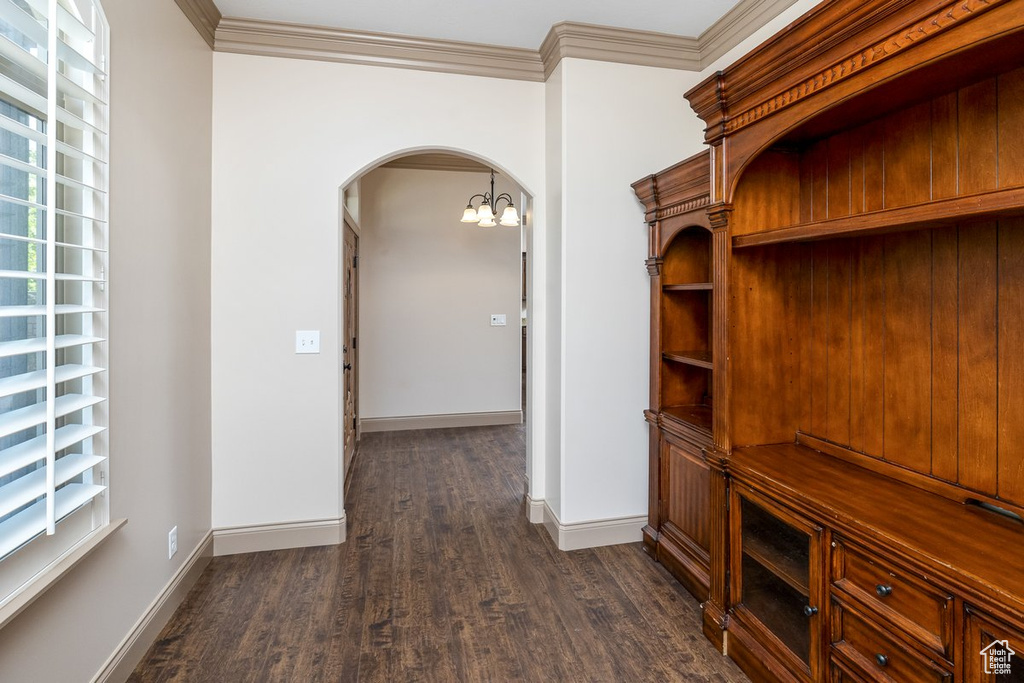 Mudroom featuring ornamental molding, a chandelier, and dark wood-type flooring