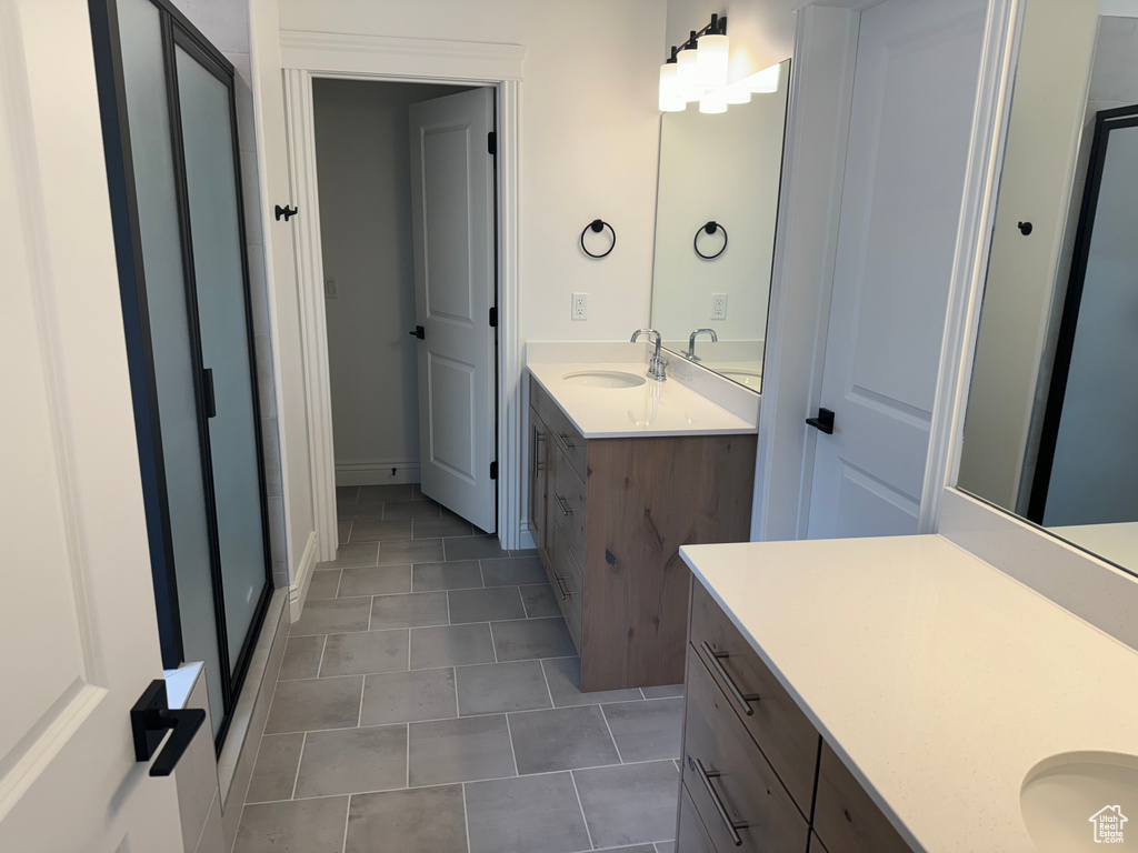 Bathroom with dual vanity and tile floors