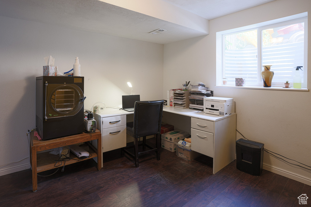 Office area with dark hardwood / wood-style flooring