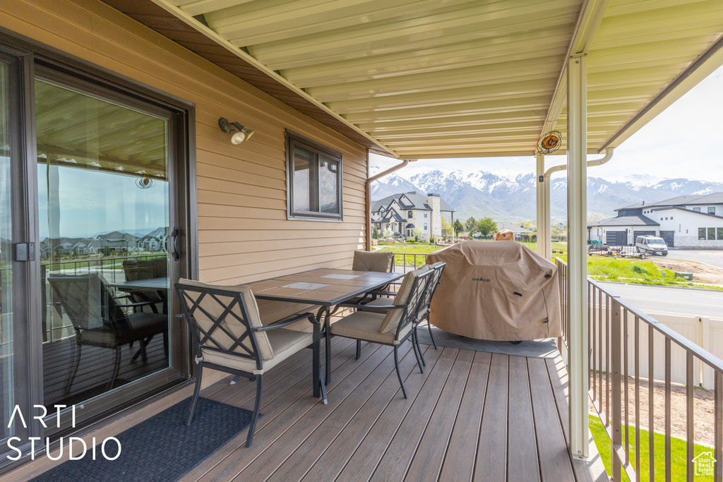 Wooden deck with a grill and a mountain view