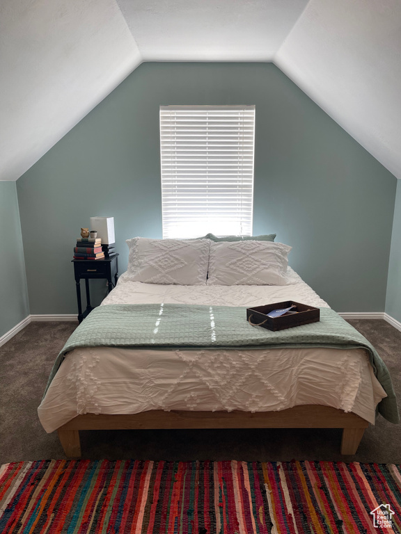 Carpeted bedroom with vaulted ceiling