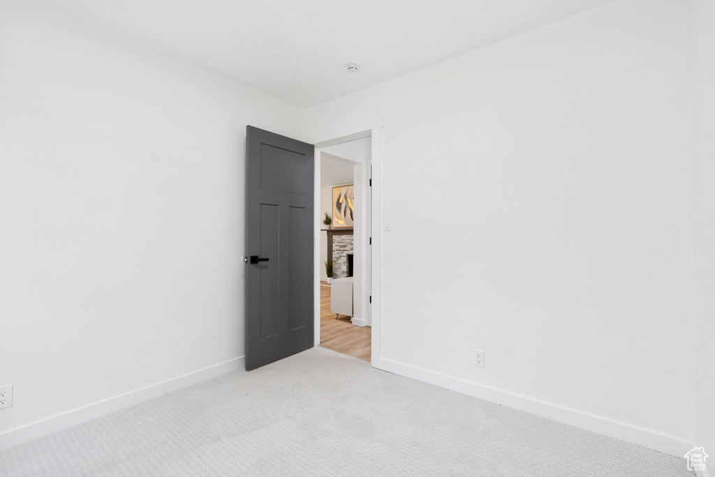 Spare room featuring light colored carpet