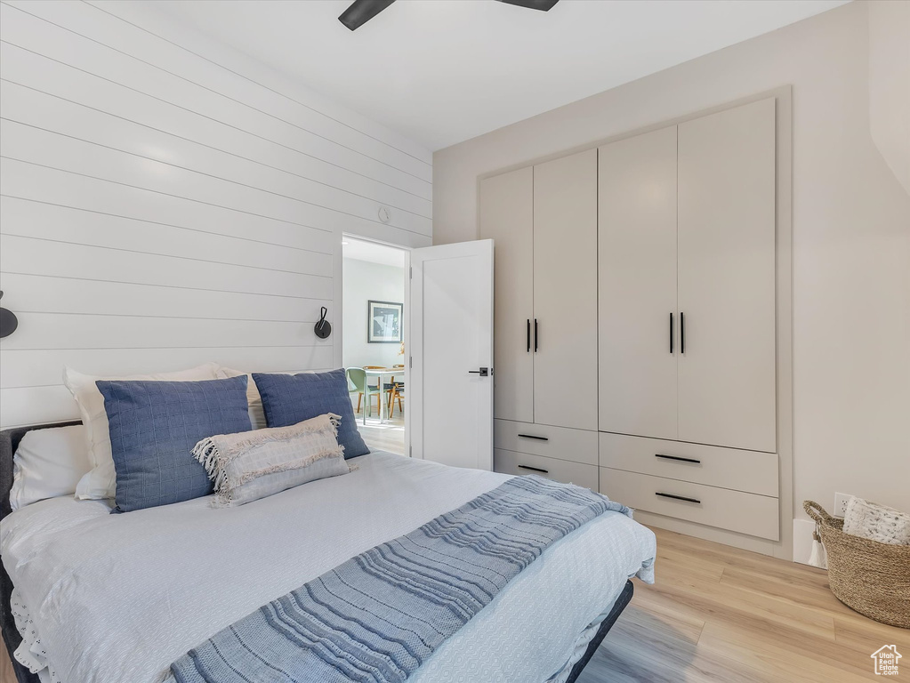 Bedroom with light hardwood / wood-style floors and ceiling fan