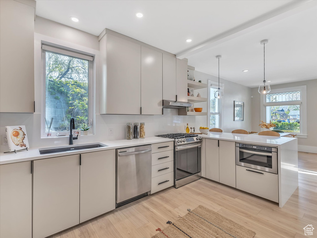 Kitchen featuring appliances with stainless steel finishes, plenty of natural light, and sink