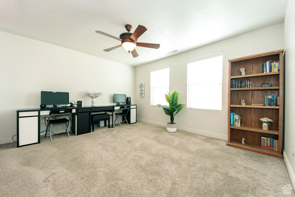 Carpeted home office with ceiling fan