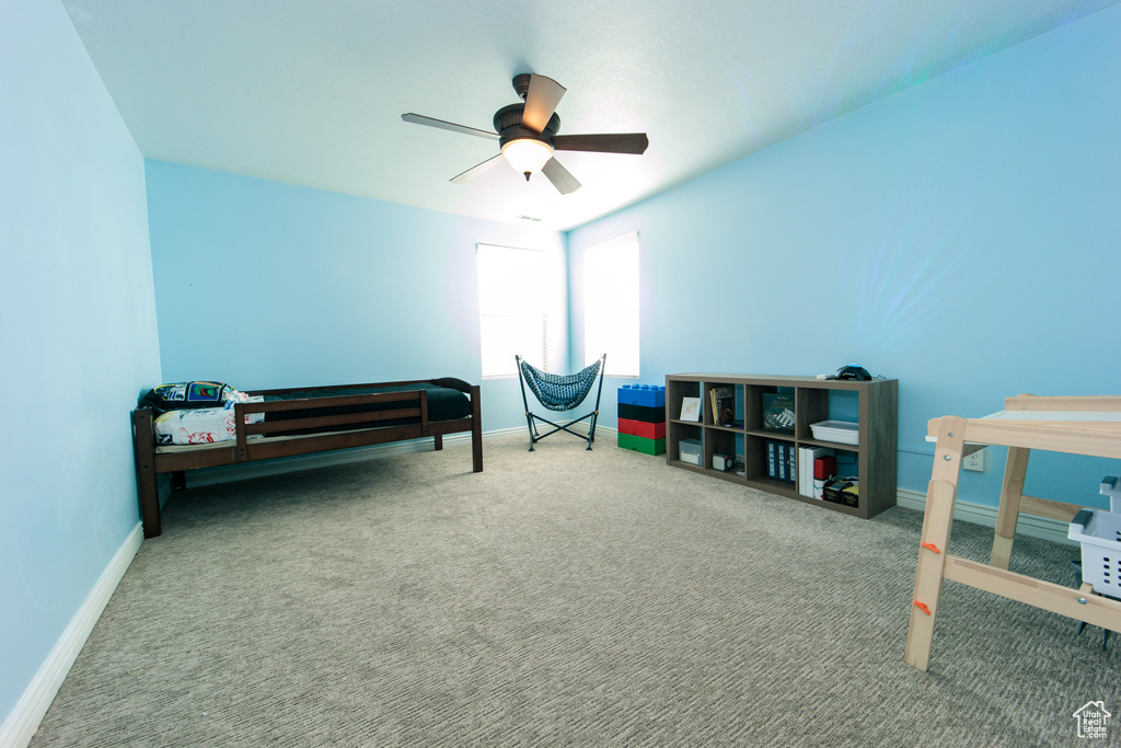 Interior space featuring ceiling fan and carpet