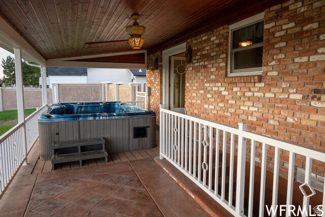 View of patio / terrace with a hot tub and ceiling fan
