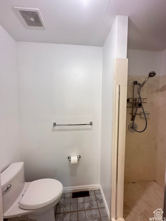 Bathroom with toilet and tile flooring