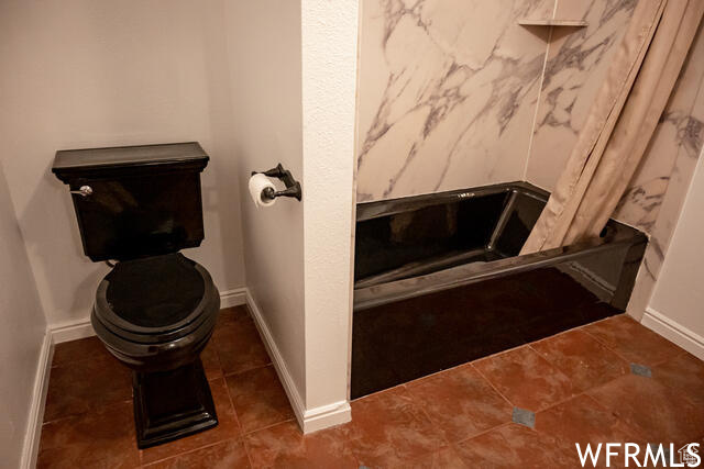 Bathroom featuring tile flooring and toilet