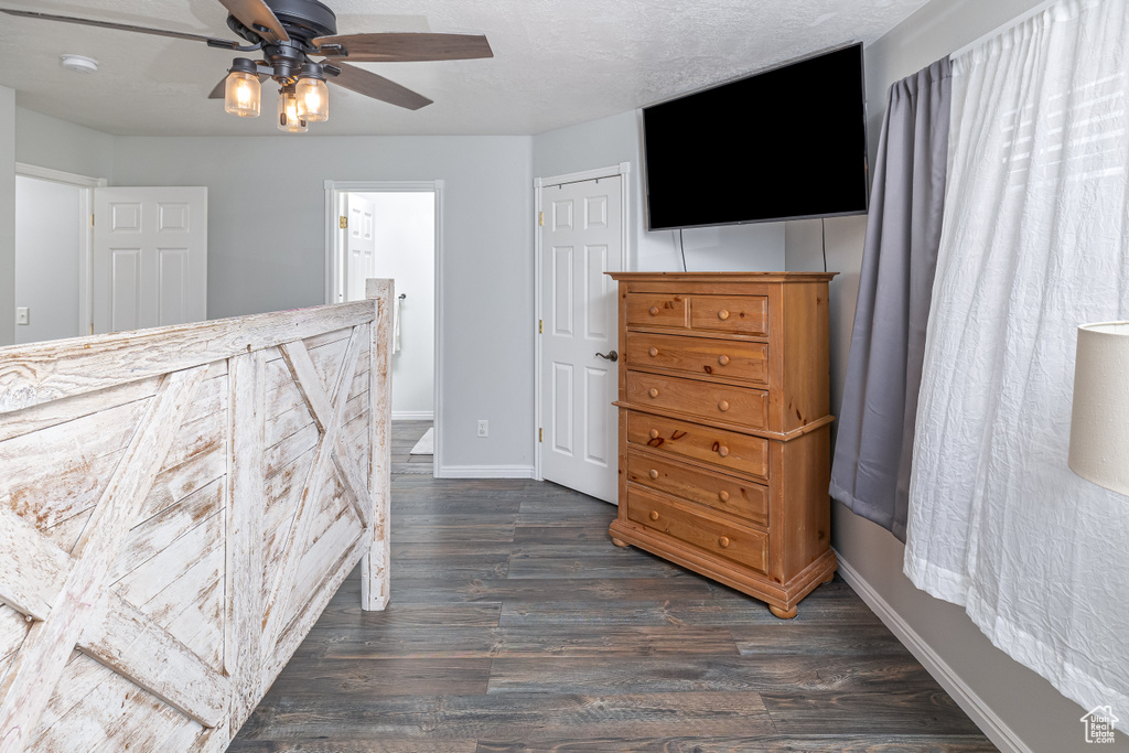 Bedroom featuring connected bathroom, ceiling fan, and dark hardwood / wood-style floors