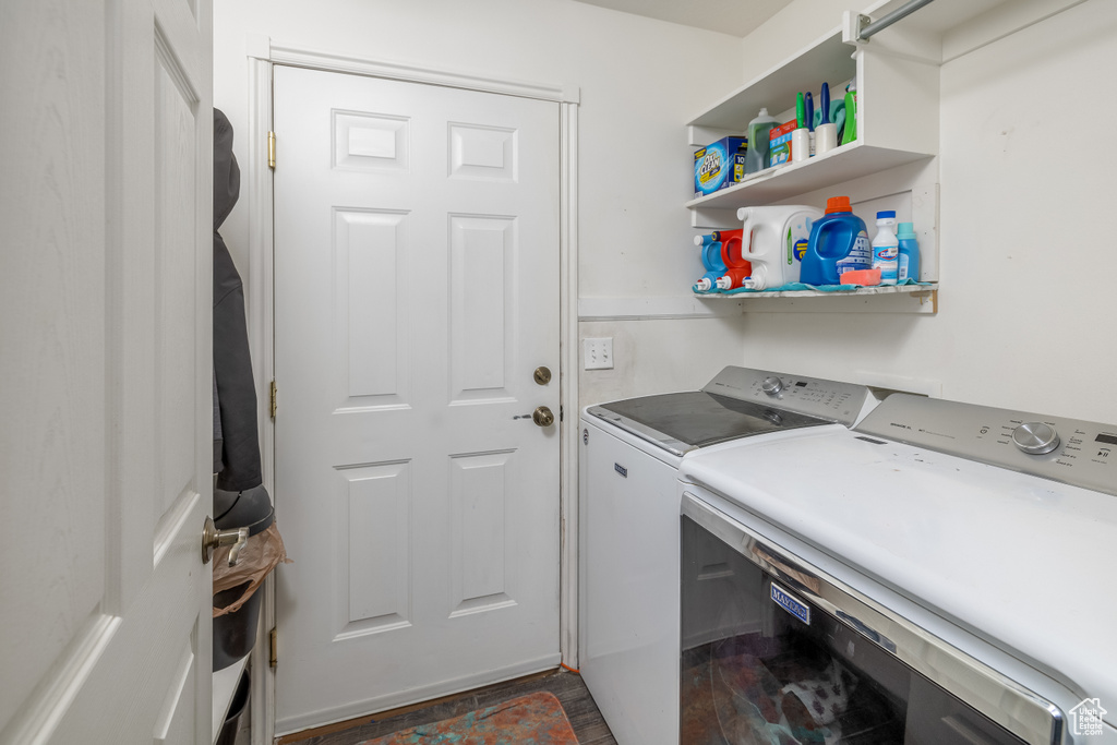 Laundry area featuring dark hardwood / wood-style flooring and independent washer and dryer