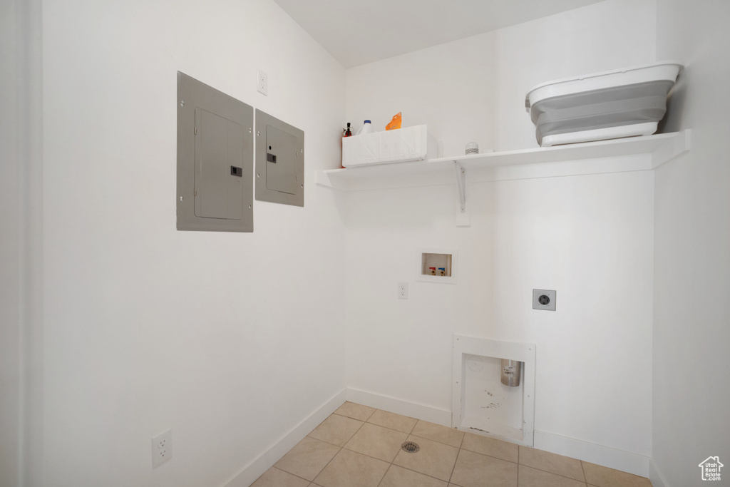 Washroom featuring washer hookup, hookup for an electric dryer, and light tile floors