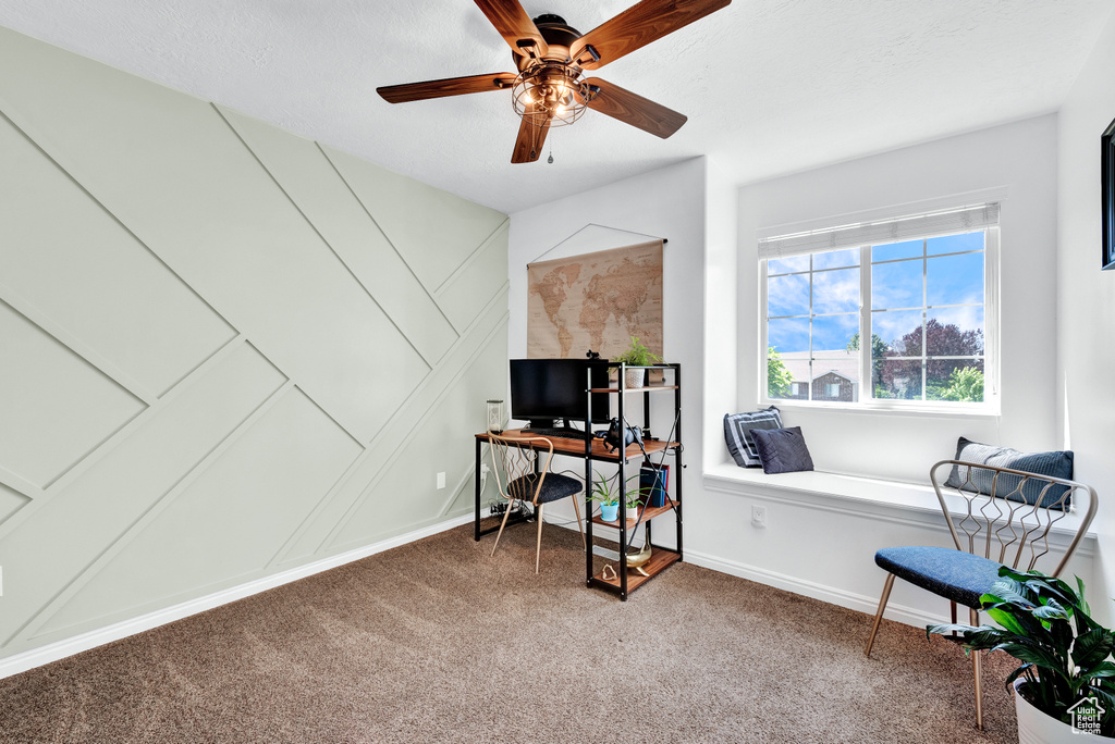Home office with ceiling fan and carpet floors